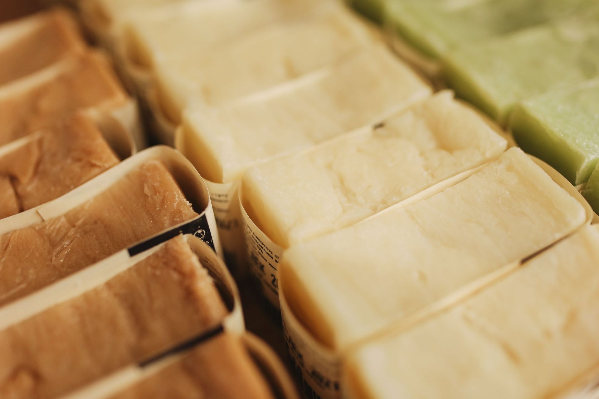 A variety of handmade natural bar soaps displayed in an organized manner, perfect for skincare and eco-friendly beauty products.