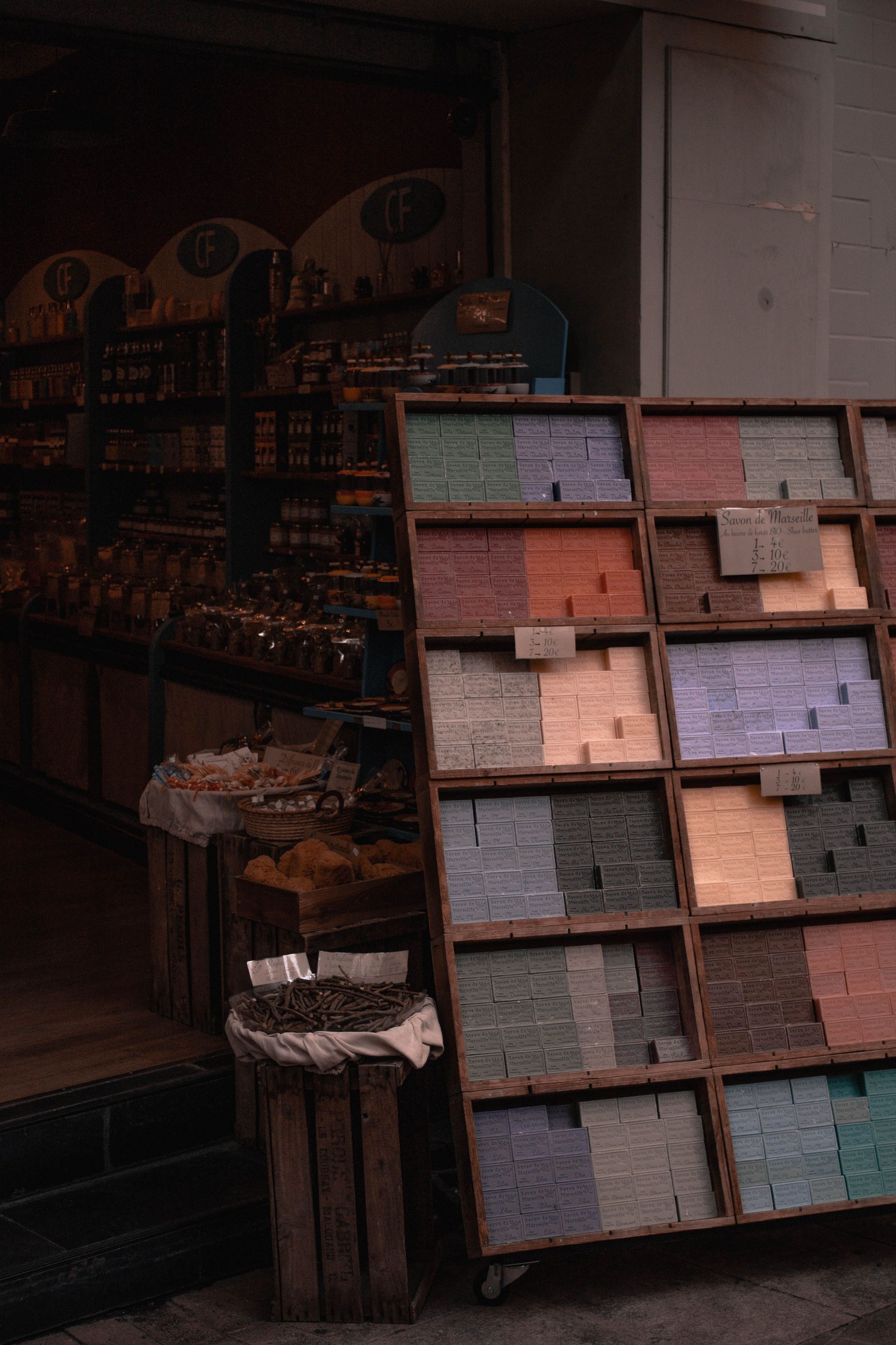 Colorful soaps on display at an urban street market stall, offering a variety of shades and textures.